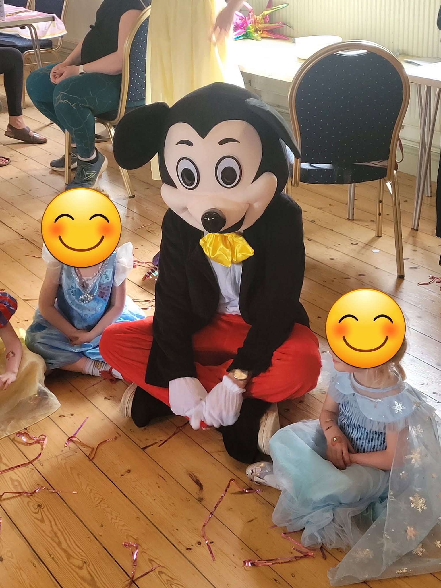 Mickey Mouse character with children at a party