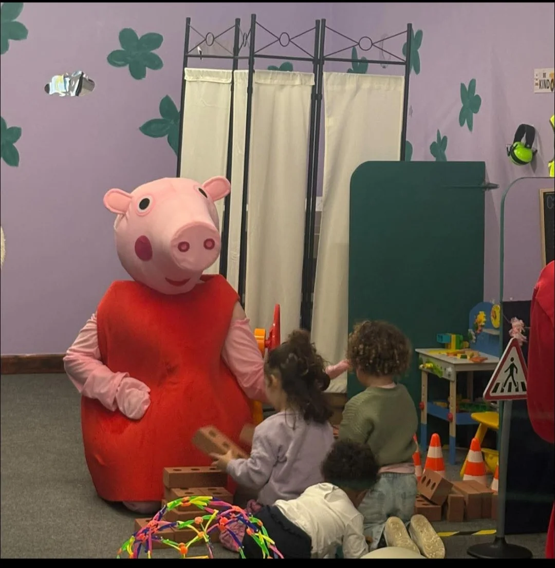 Child meeting a blue cat character costume at home